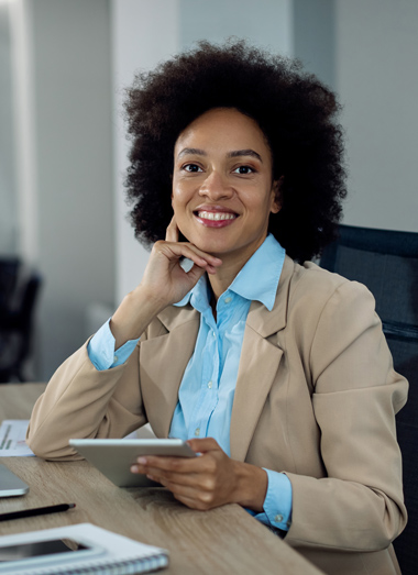 happy-african-businesswoman-working-touchpad-office